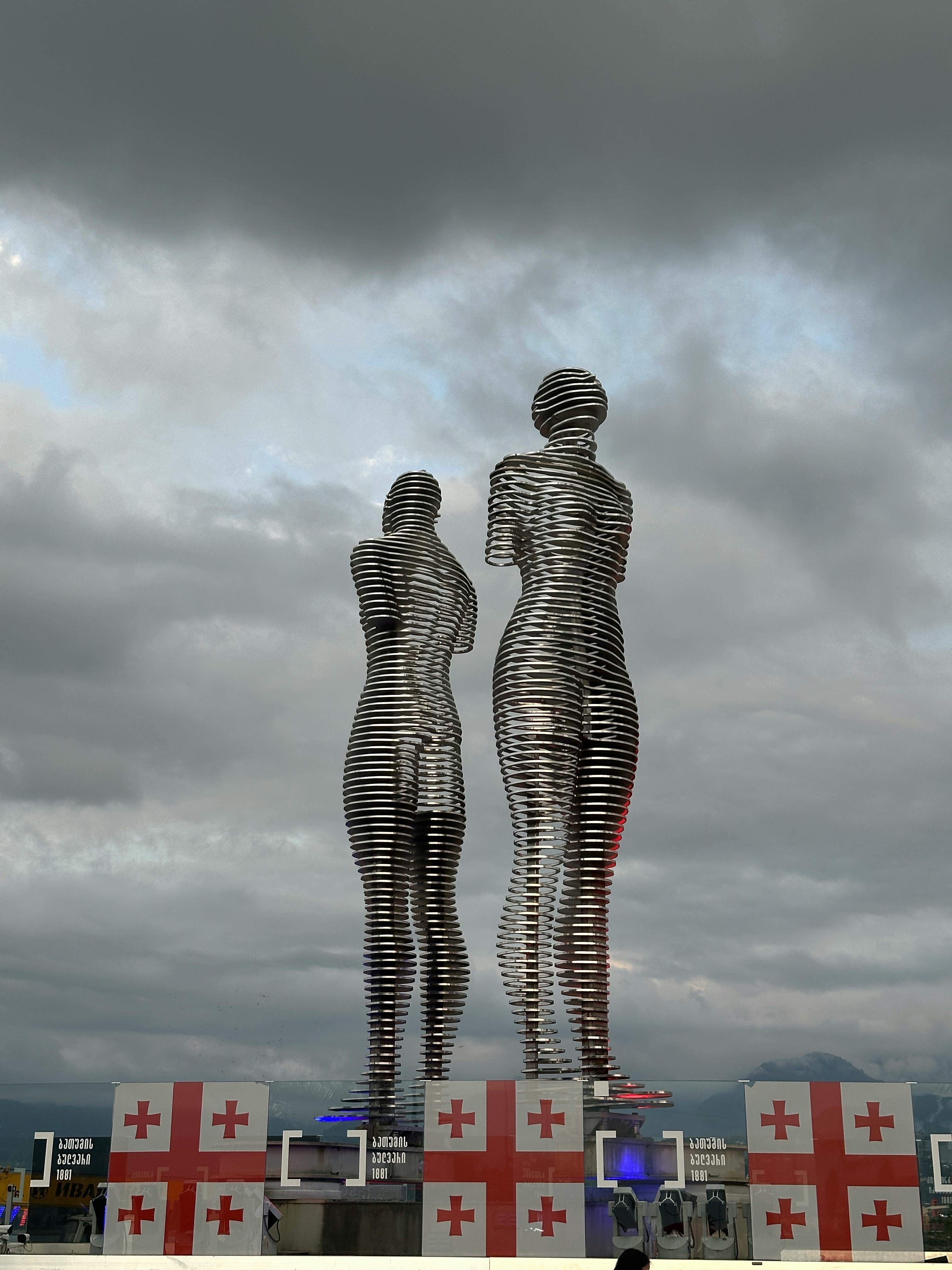 Stunning view of the Ali and Nino sculpture in Batumi against a cloudy sky.