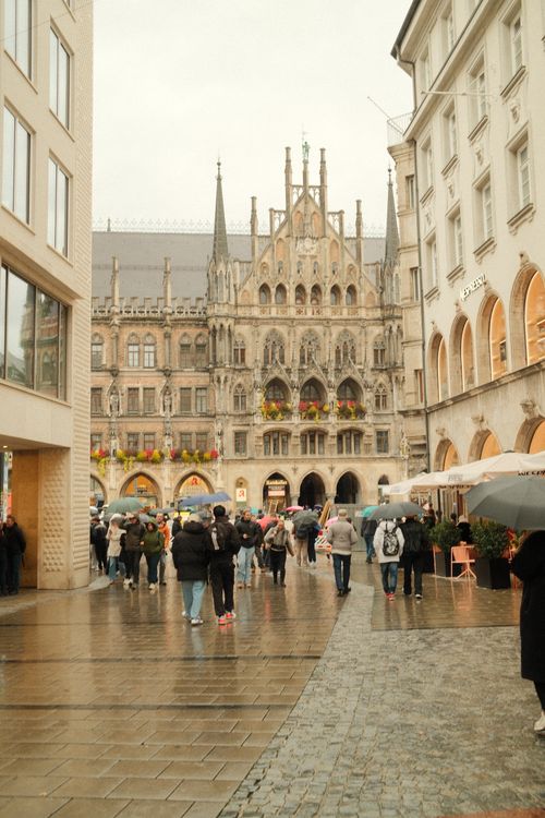 Free Crowds with umbrellas explore historic Marienplatz in rainy Munich, Germany. Stock Photo