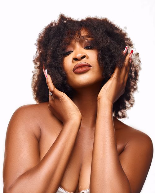 Free Graceful portrait of a woman with curly hair, highlighting elegance and confidence. Stock Photo