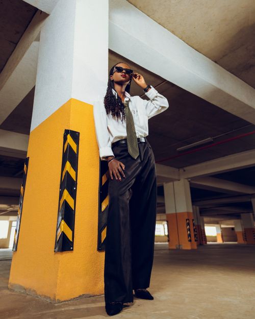 Free Chic woman in sunglasses posing in an industrial parking garage. Stock Photo