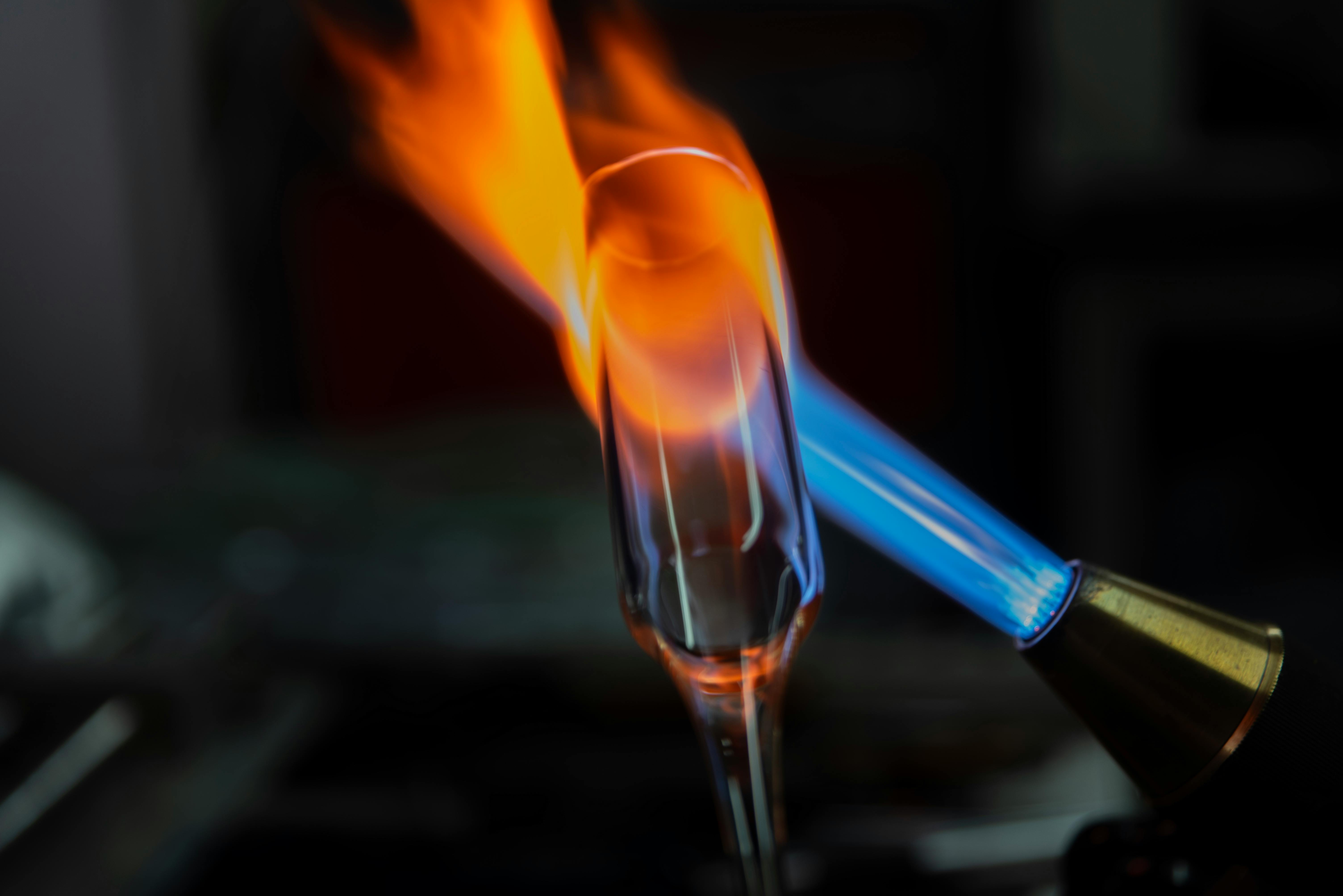 A captivating close-up of glassblowing with an intense flame shaping glass.