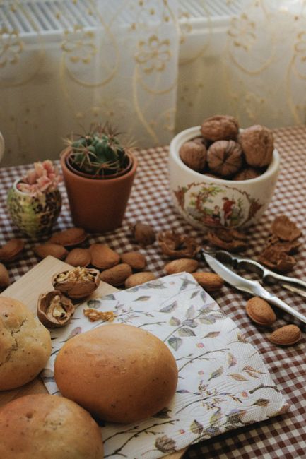 Cozy breakfast setting with bread, nuts, and rustic decor on a checkered tablecloth. - Where to Buy Quality Nuts Online in Pakistan