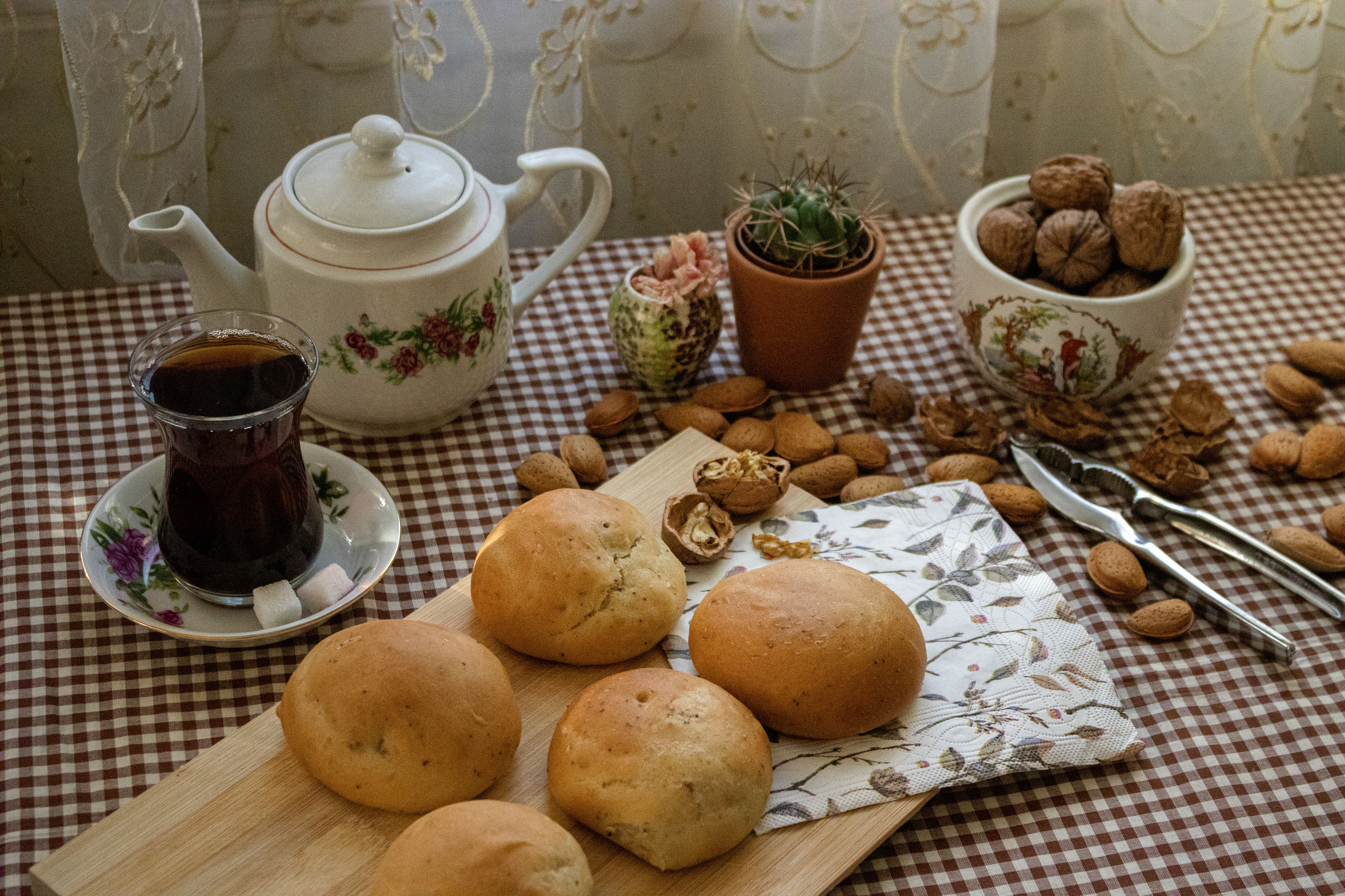 Cozy Tea Time with Fresh Bread and Nuts · Free Stock Photo