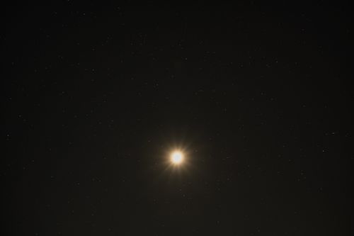 Free A stunning view of the bright moon surrounded by a starry sky over Poprad, Slovakia. Stock Photo