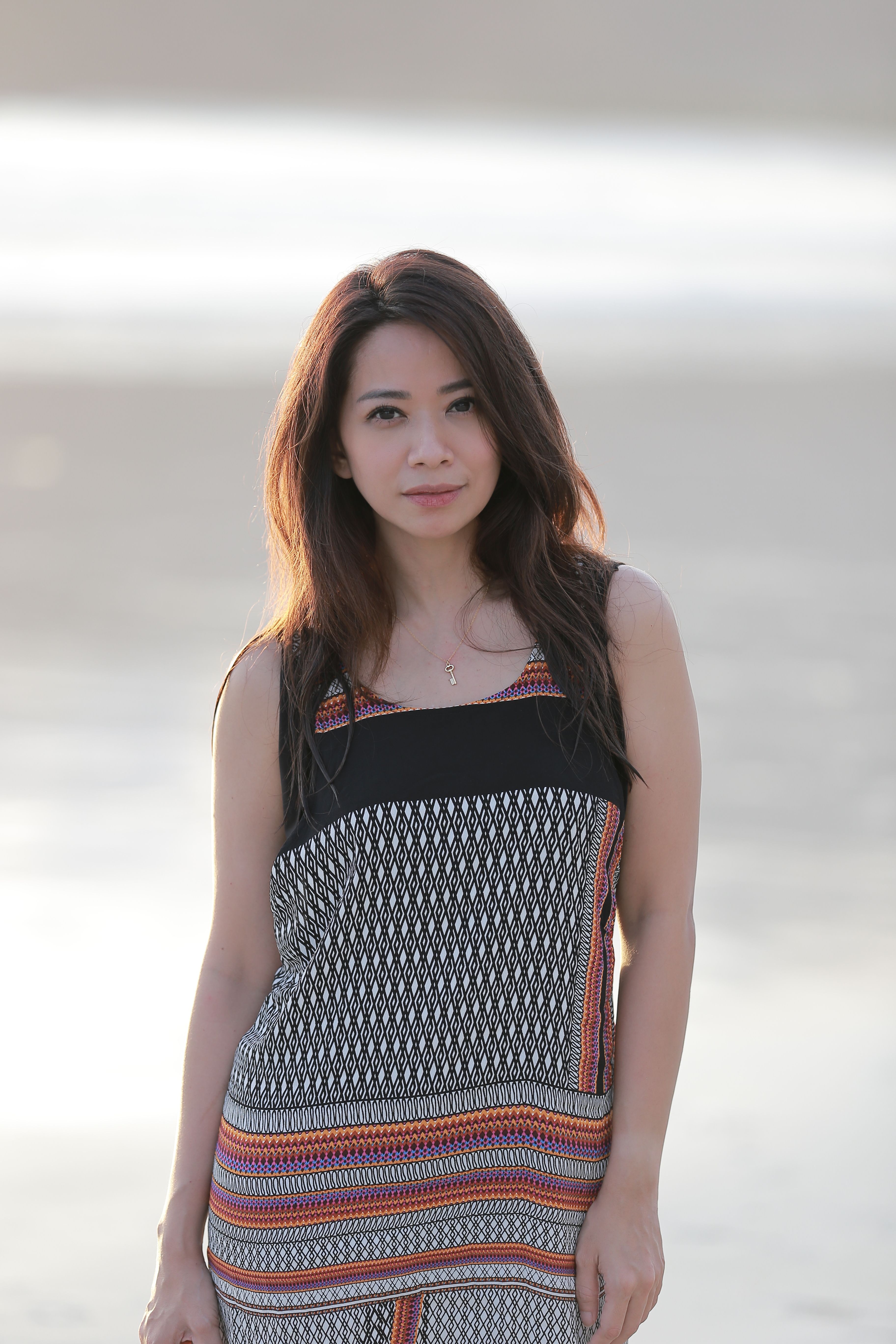A tranquil portrait of a woman on a sunny beach in Bali, conveying relaxation and lifestyle vibes.
