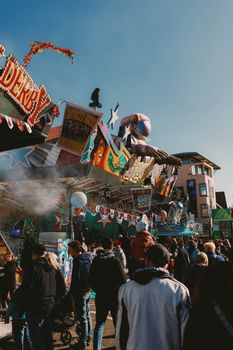 Vibrant scene of people enjoying amusement rides at Lullusfest fairground in Bad Hersfeld, Germany.