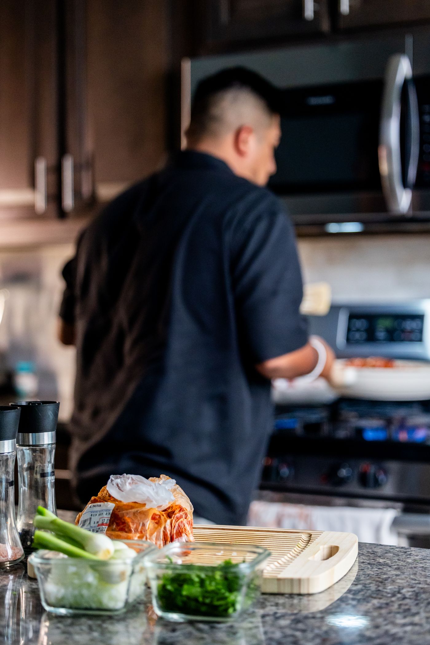 Home cook preparing a meal with fresh ingredients in a bright modern kitchen