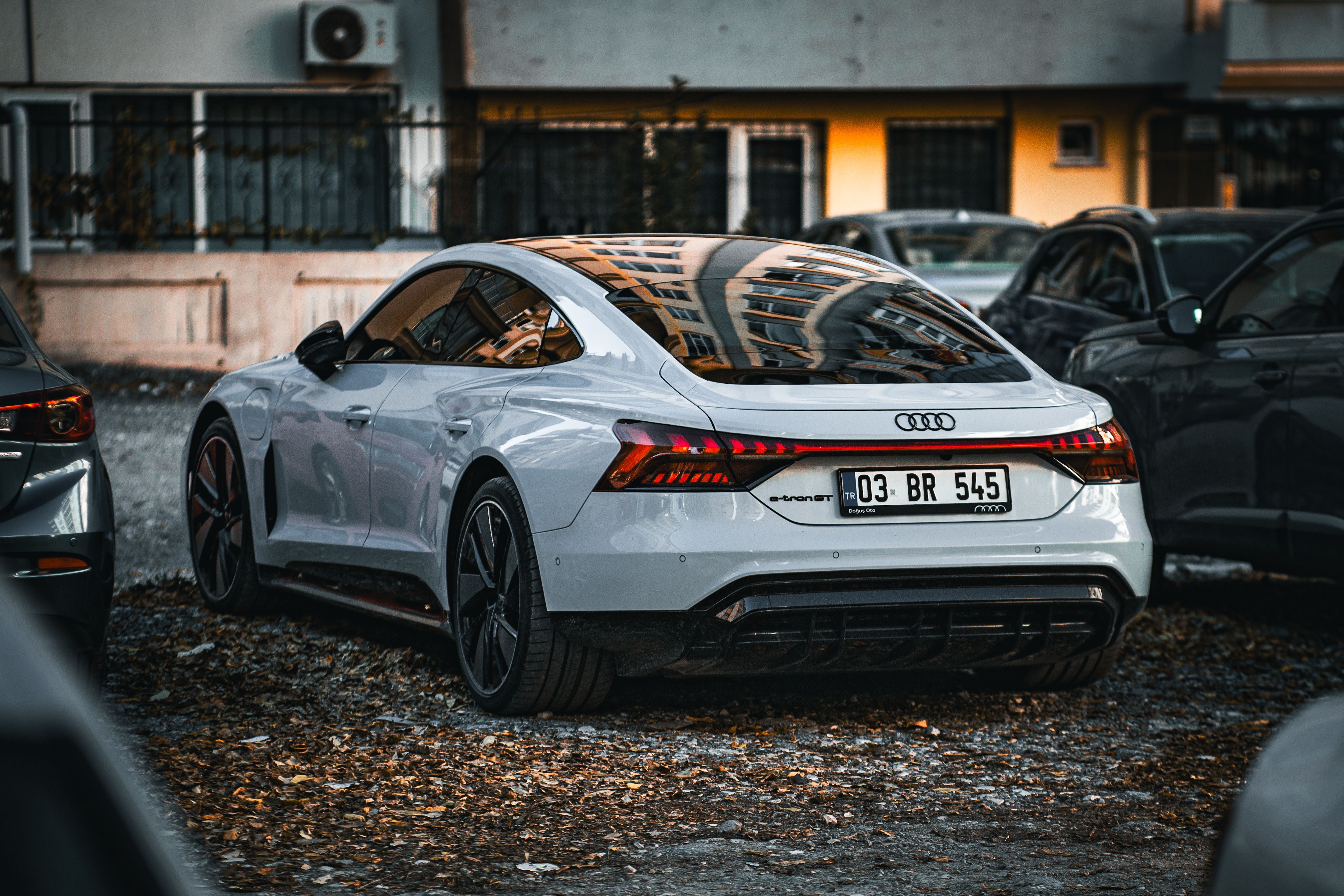 White sports car parked in an urban area showing modern design and luxury features.
