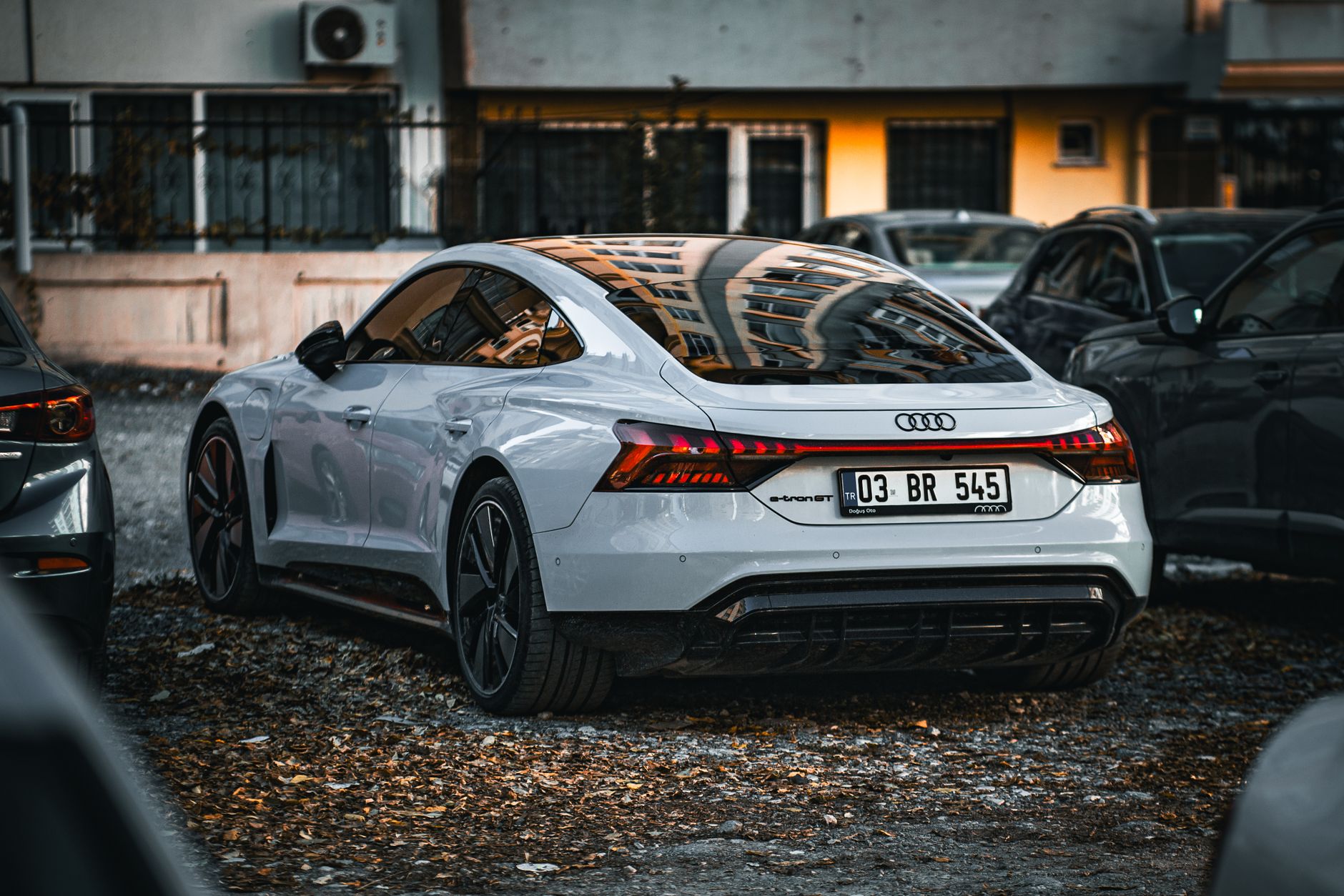 White sports car parked in an urban area showing modern design and luxury features.
