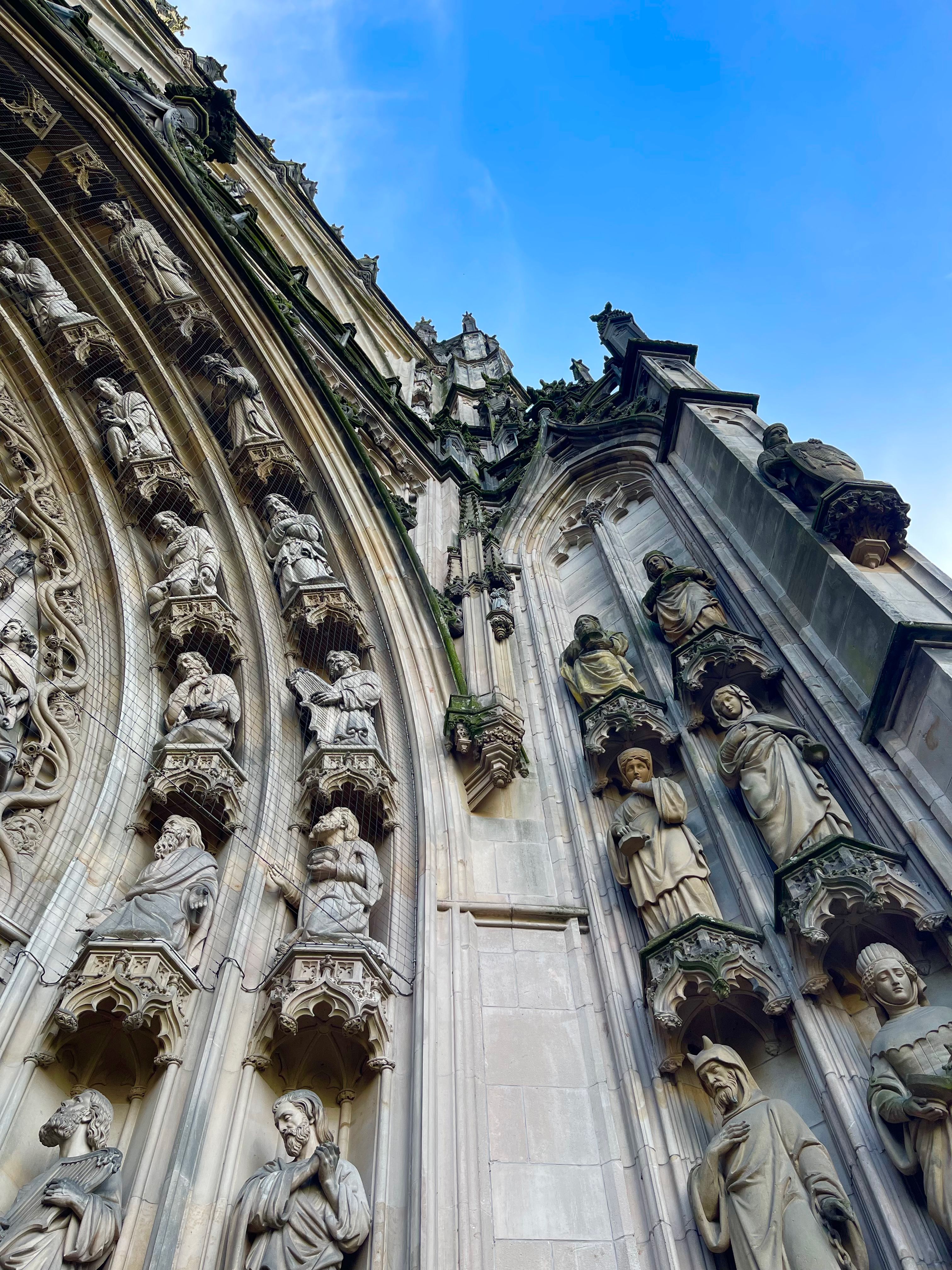 A detailed view of the Gothic statues adorning St. John's Cathedral in 's-Hertogenbosch, Netherlands.