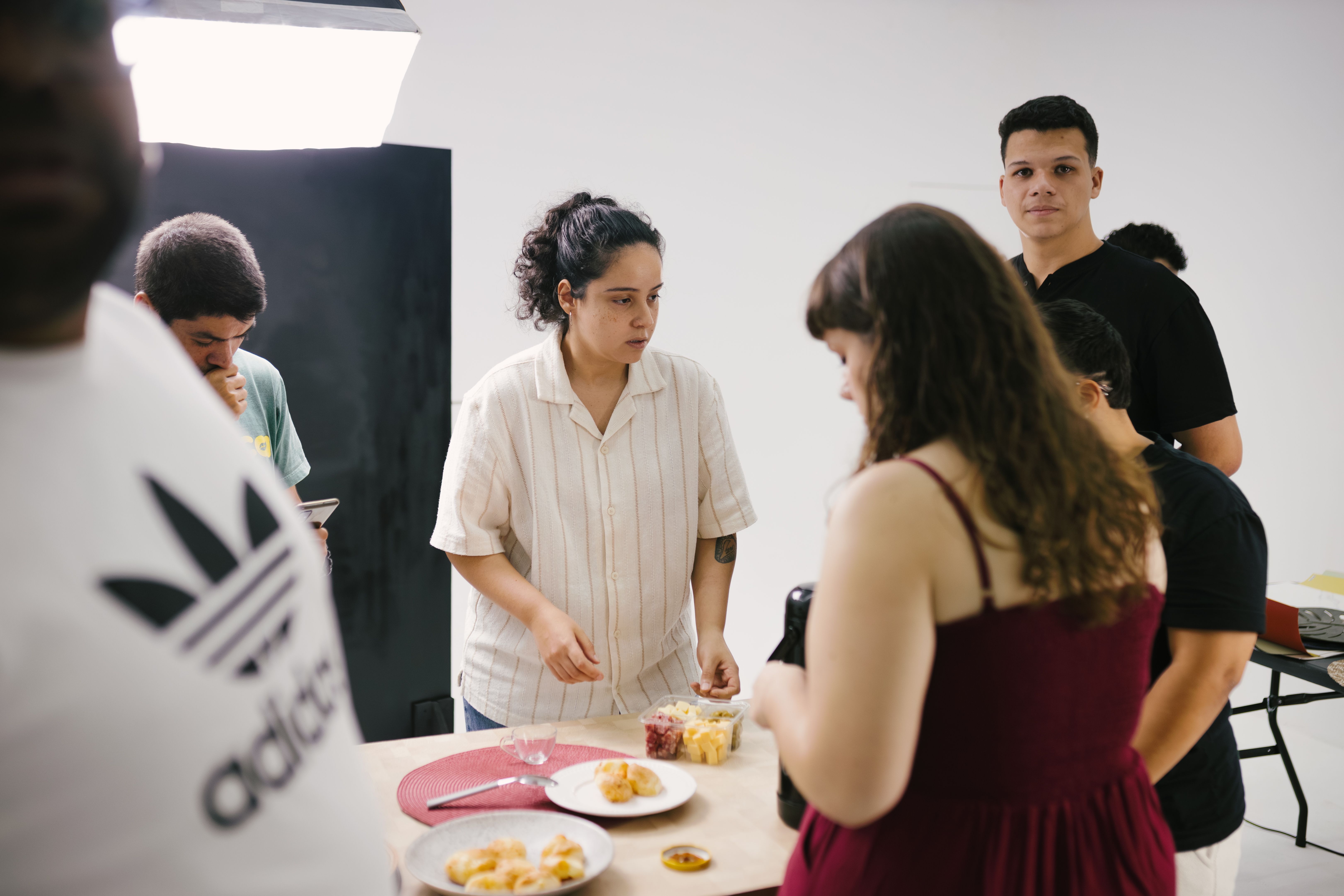 diverse group of people sharing a meal and laughing around a crowded table