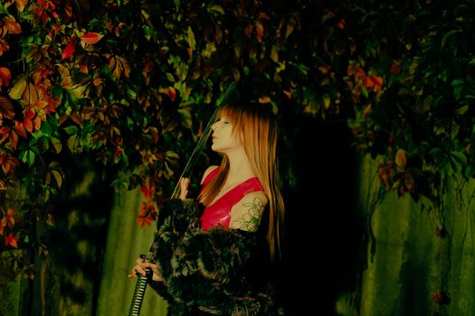 A woman in a red outfit with a katana surrounded by vibrant foliage.