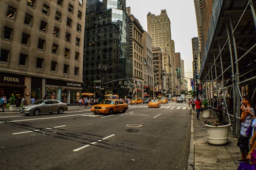 A lively street view of Midtown Manhattan capturing iconic yellow taxis and tall buildings.