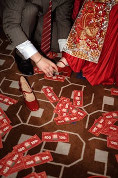 Traditional wedding ceremony with scattered red envelopes symbolizing prosperity and luck.
