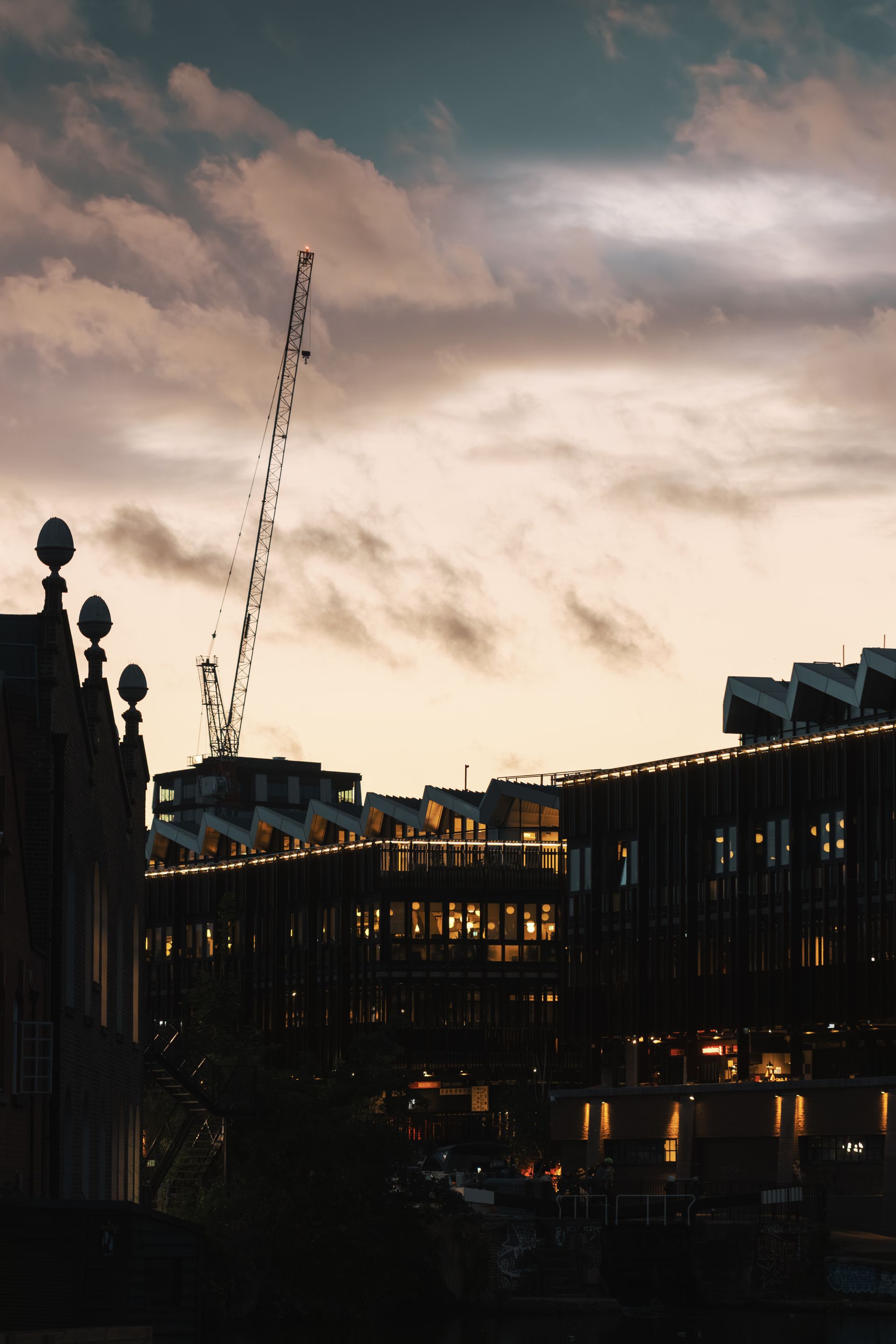City skyline at dusk with construction cranes