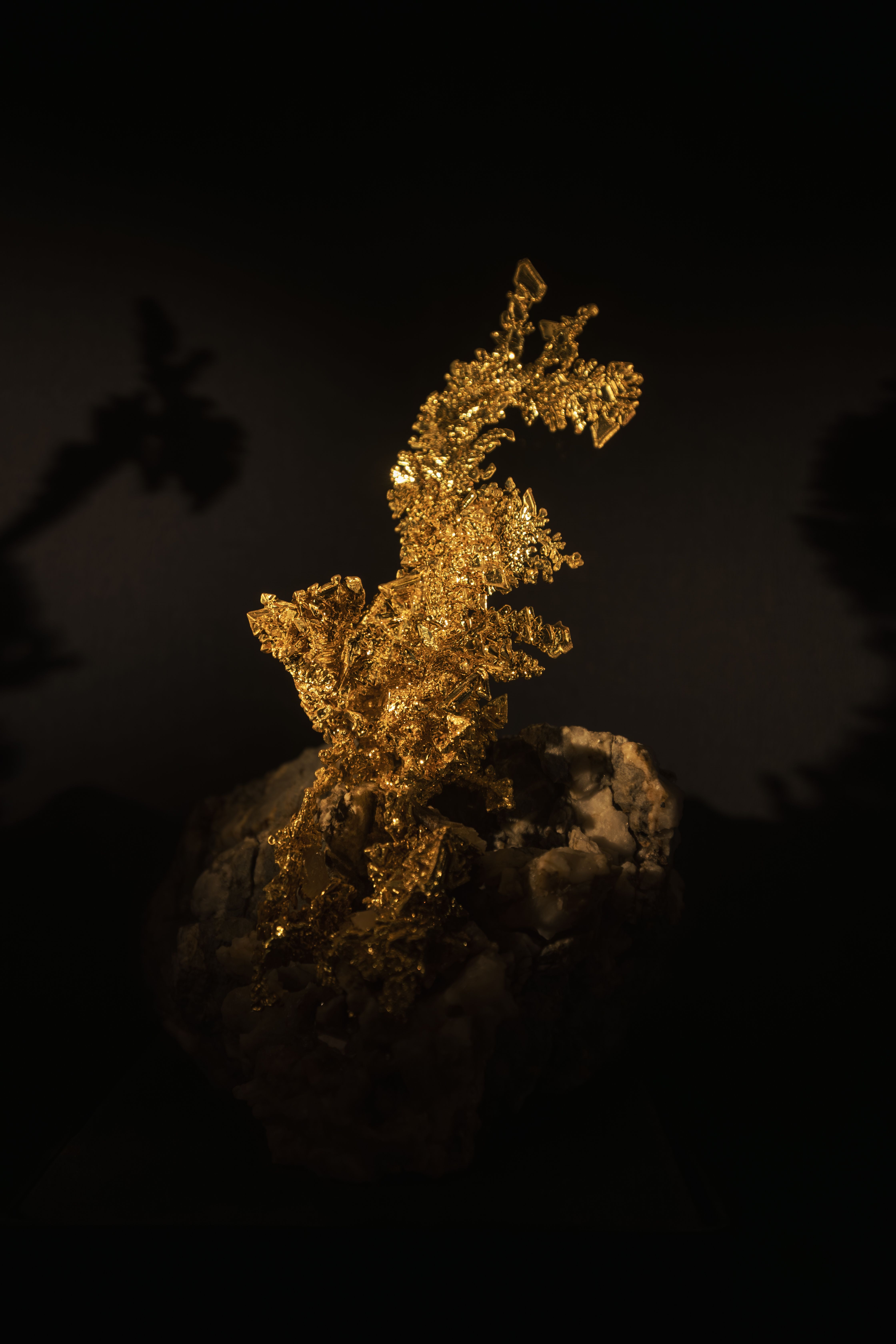 Stunning macro shot of a natural gold nugget against a dark background, highlighting its texture and luster.