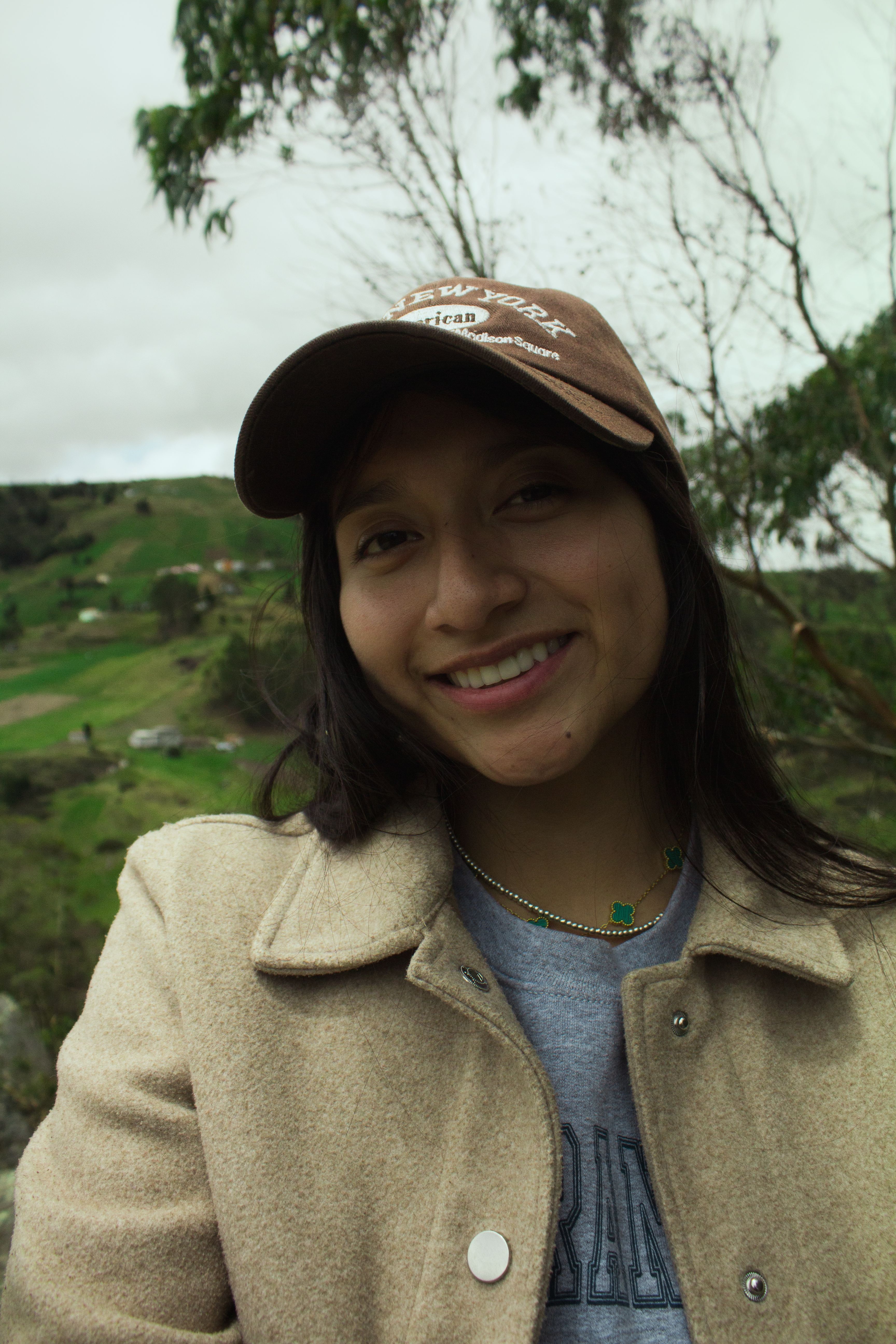A cheerful woman enjoying a scenic view in Cuenca, Azuay, Ecuador.