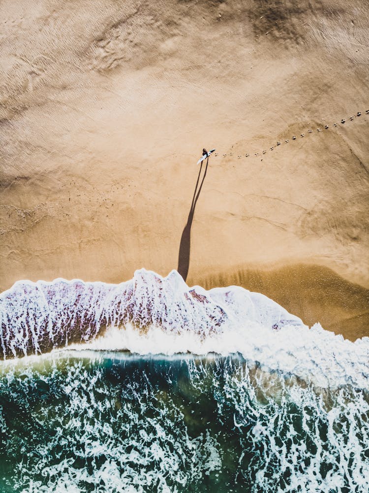 Person Walking Near Shore