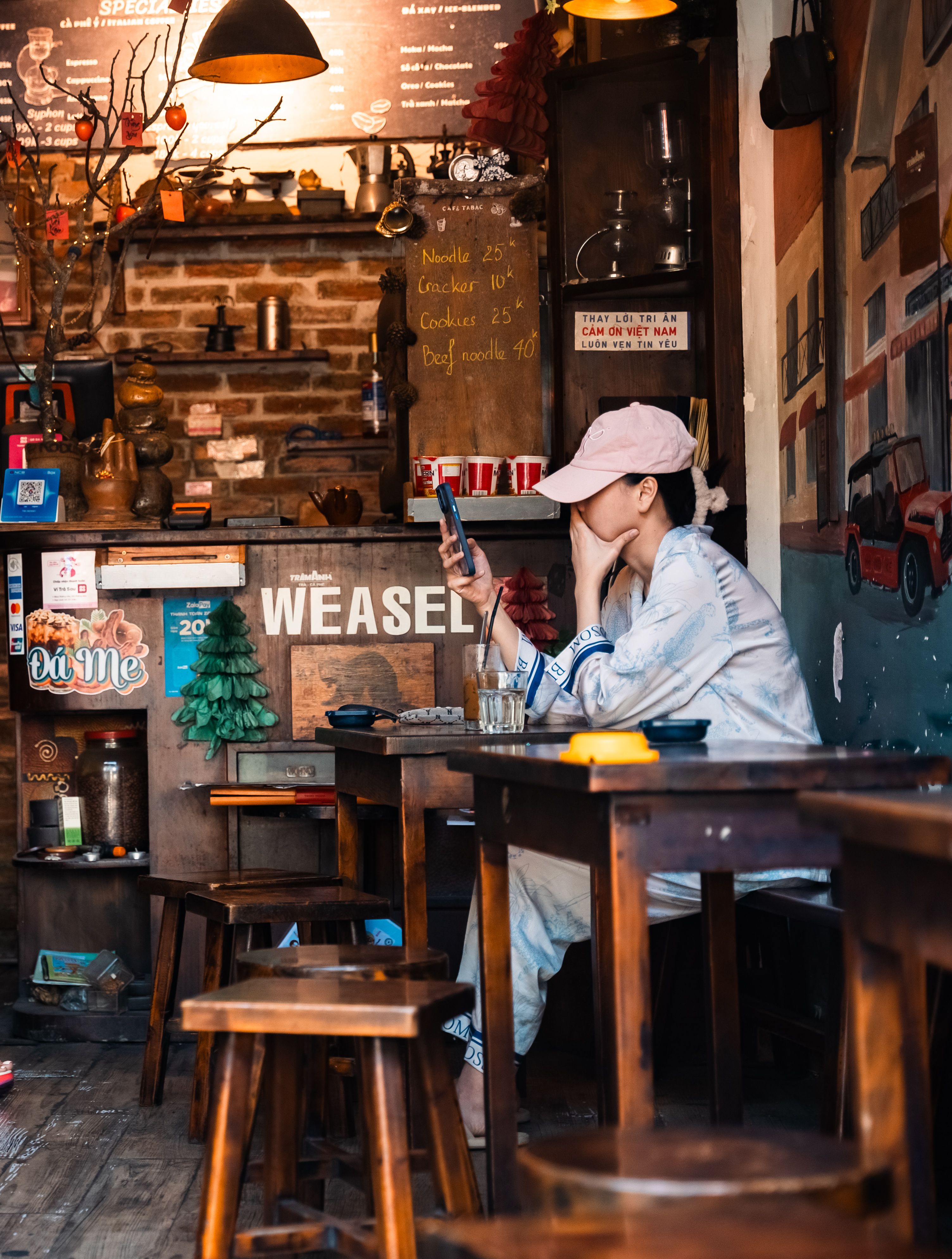 Small business owner checking phone notifications during work break