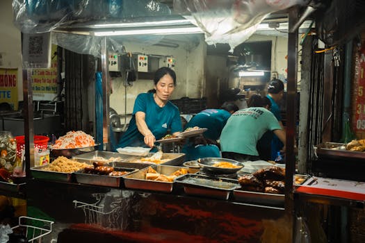 Street food vendor serving tasty dishes at a bustling night market. Authentic urban culinary scene.