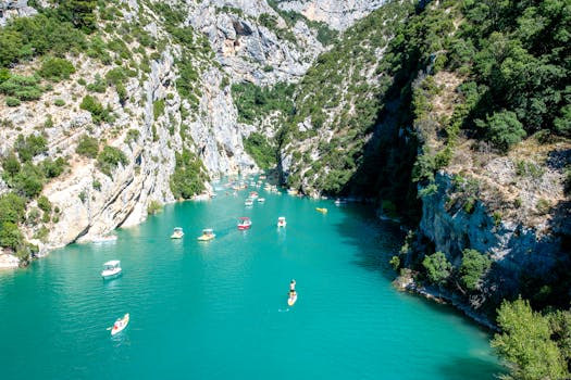 Beautiful landscape of Verdon Gorge featuring boats in turquoise river, Provence-Alpes-Côte d'Azur.