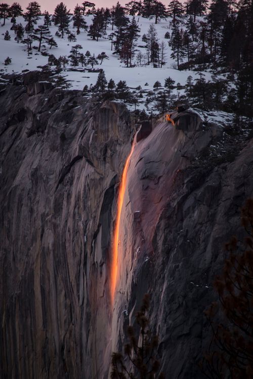 Free Horsetail Fall in Yosemite appears as a glowing cascade during sunset. Stock Photo