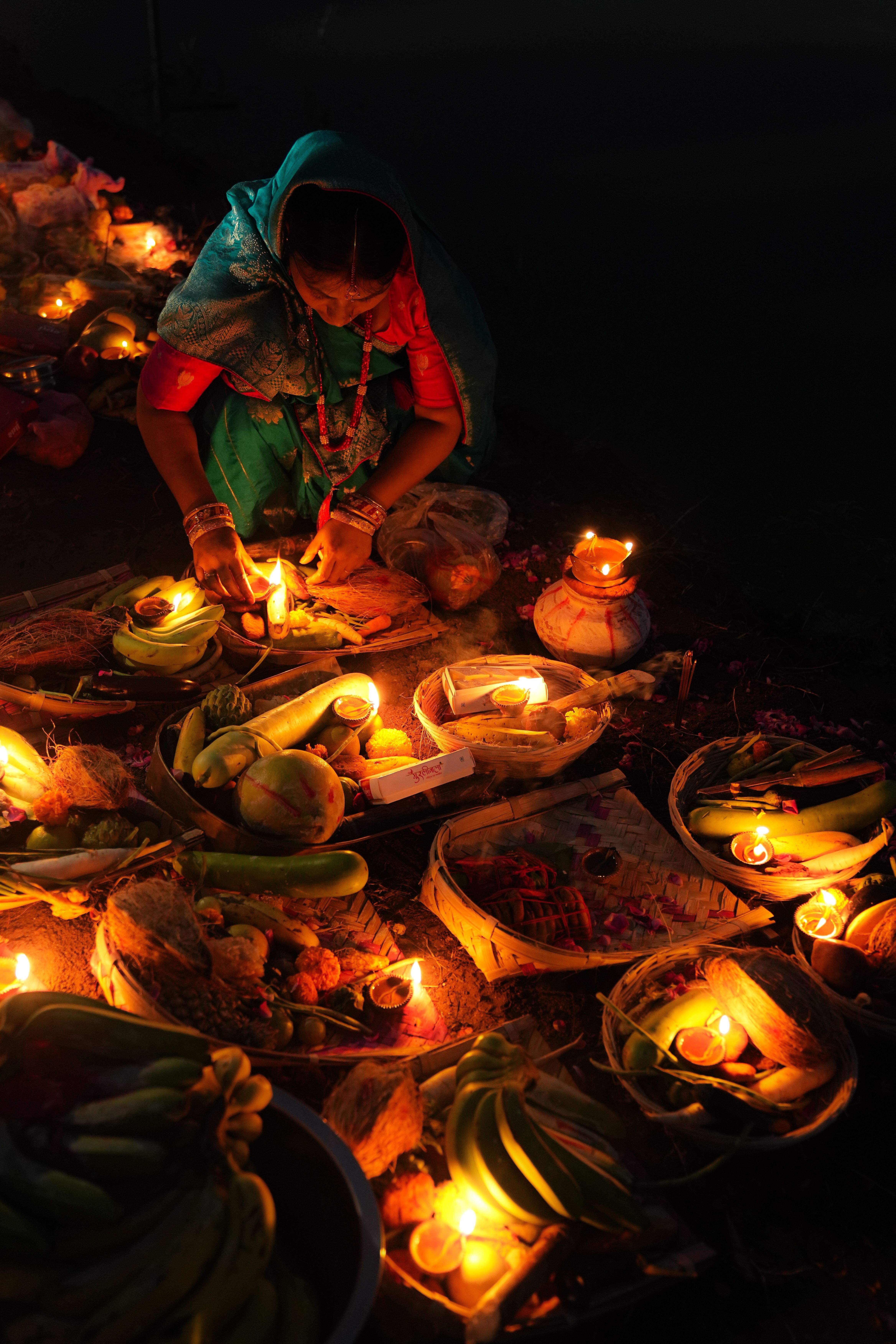 Woman Performing Ritual with Offerings and Candles · Free Stock Photo