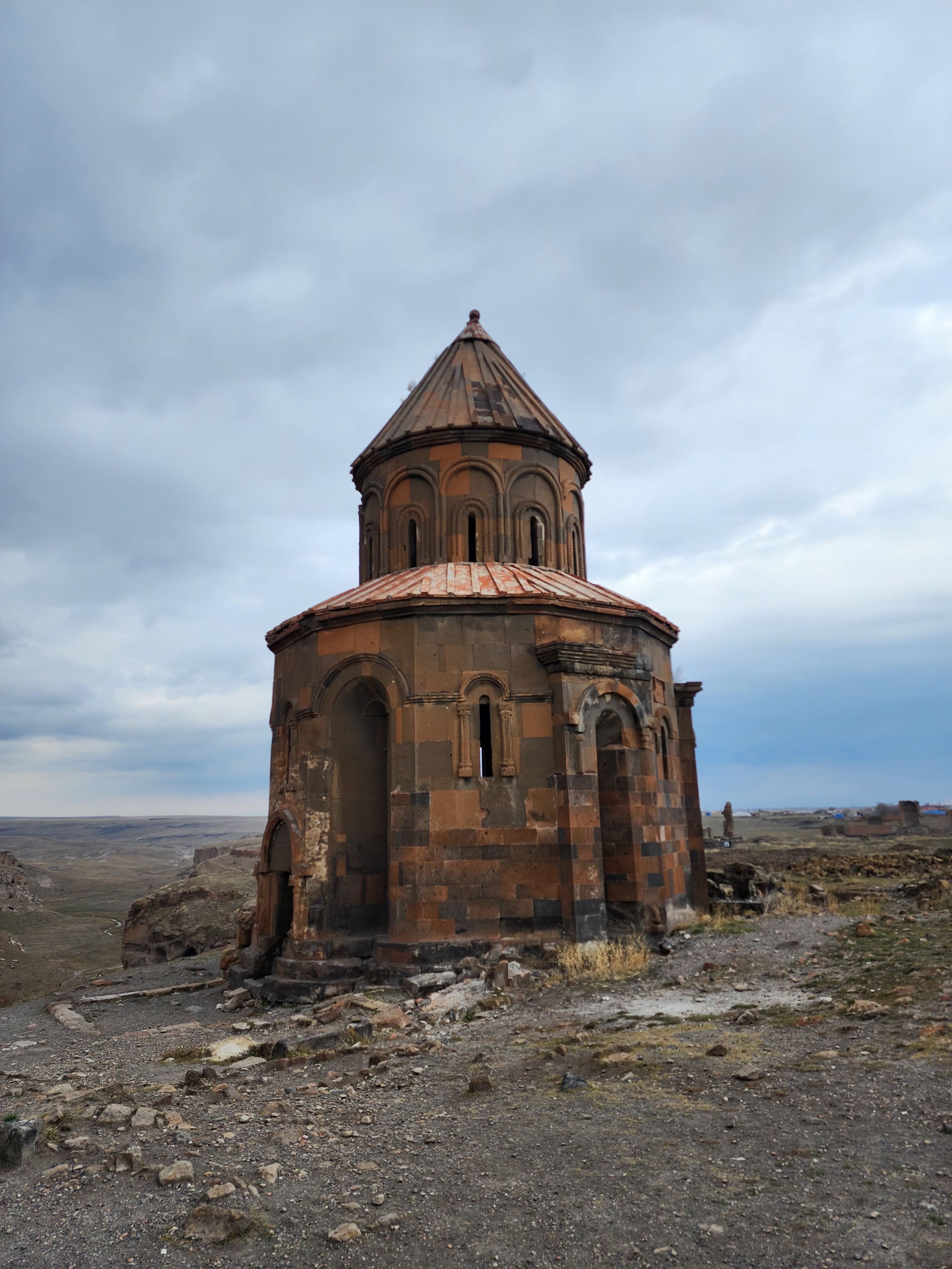 Explore the historical ruins of an ancient church in Ani, Turkey, under a dramatic sky.