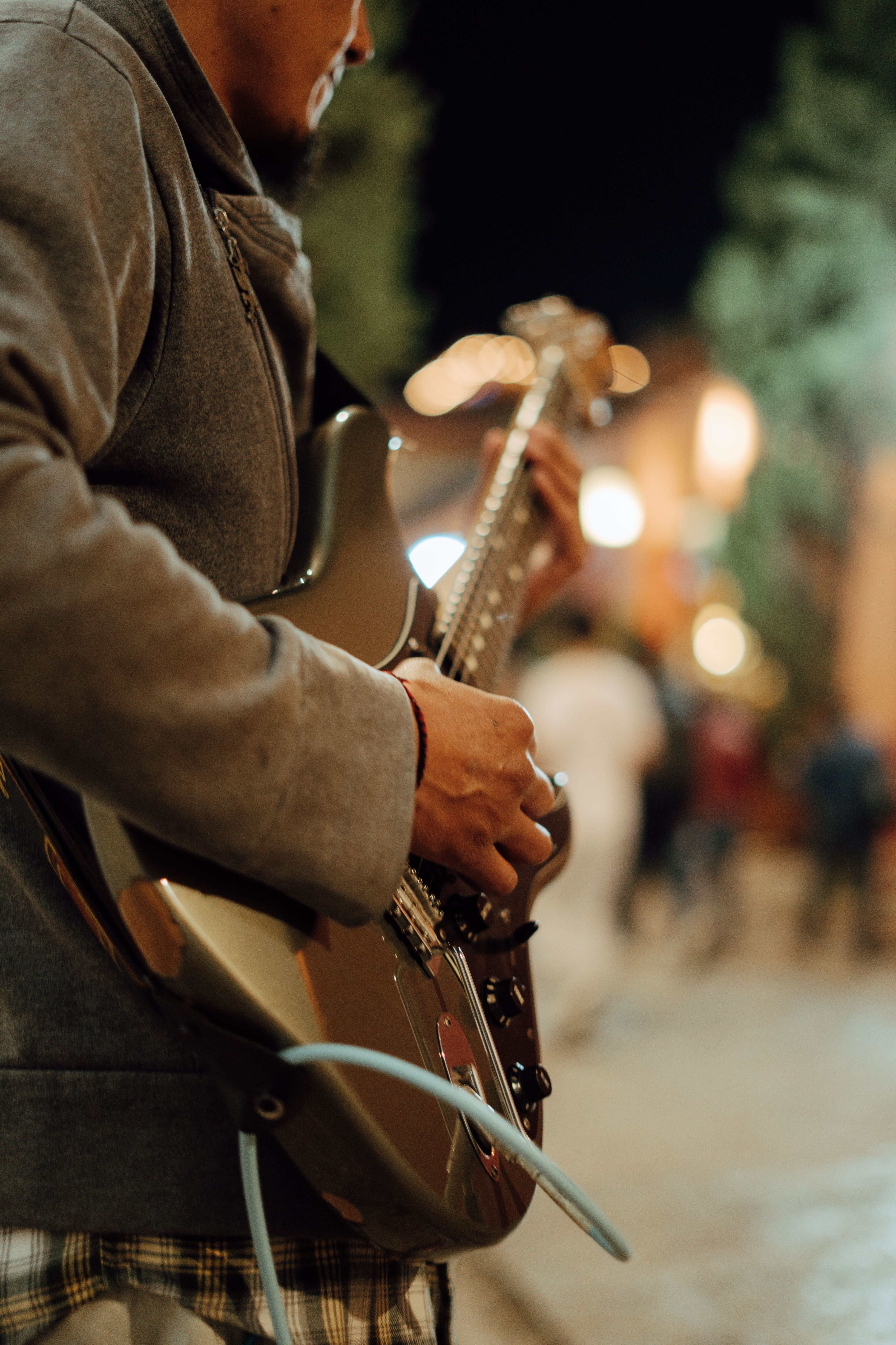 Street Musician Playing Electric Guitar at Night · Free Stock Photo