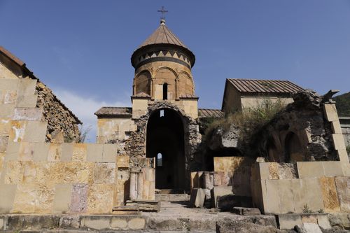 Free Explore the historical architecture of an ancient stone monastery in ruins, bathed in sunlight. Stock Photo