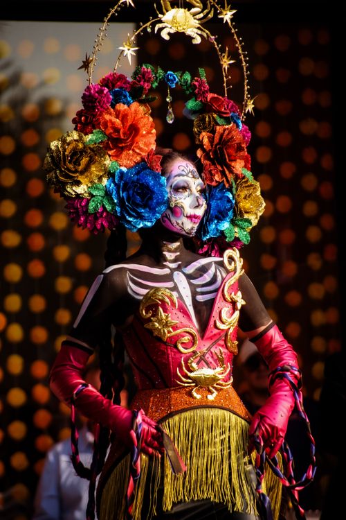 Free Colorful Day of the Dead costume with floral headdress in vibrant celebration in Mexico City. Stock Photo