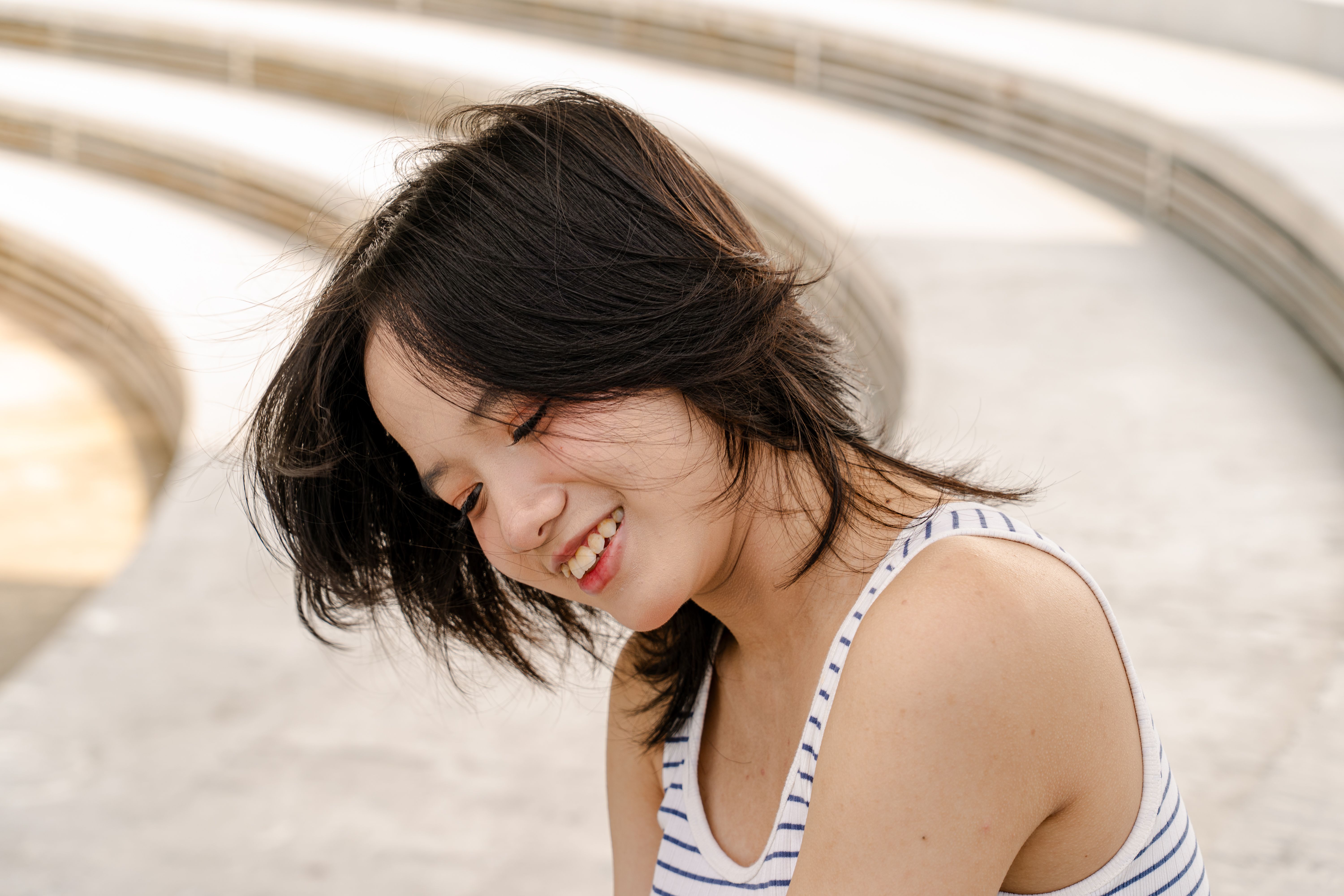 Smiling Woman in Striped Top Outdoors · Free Stock Photo