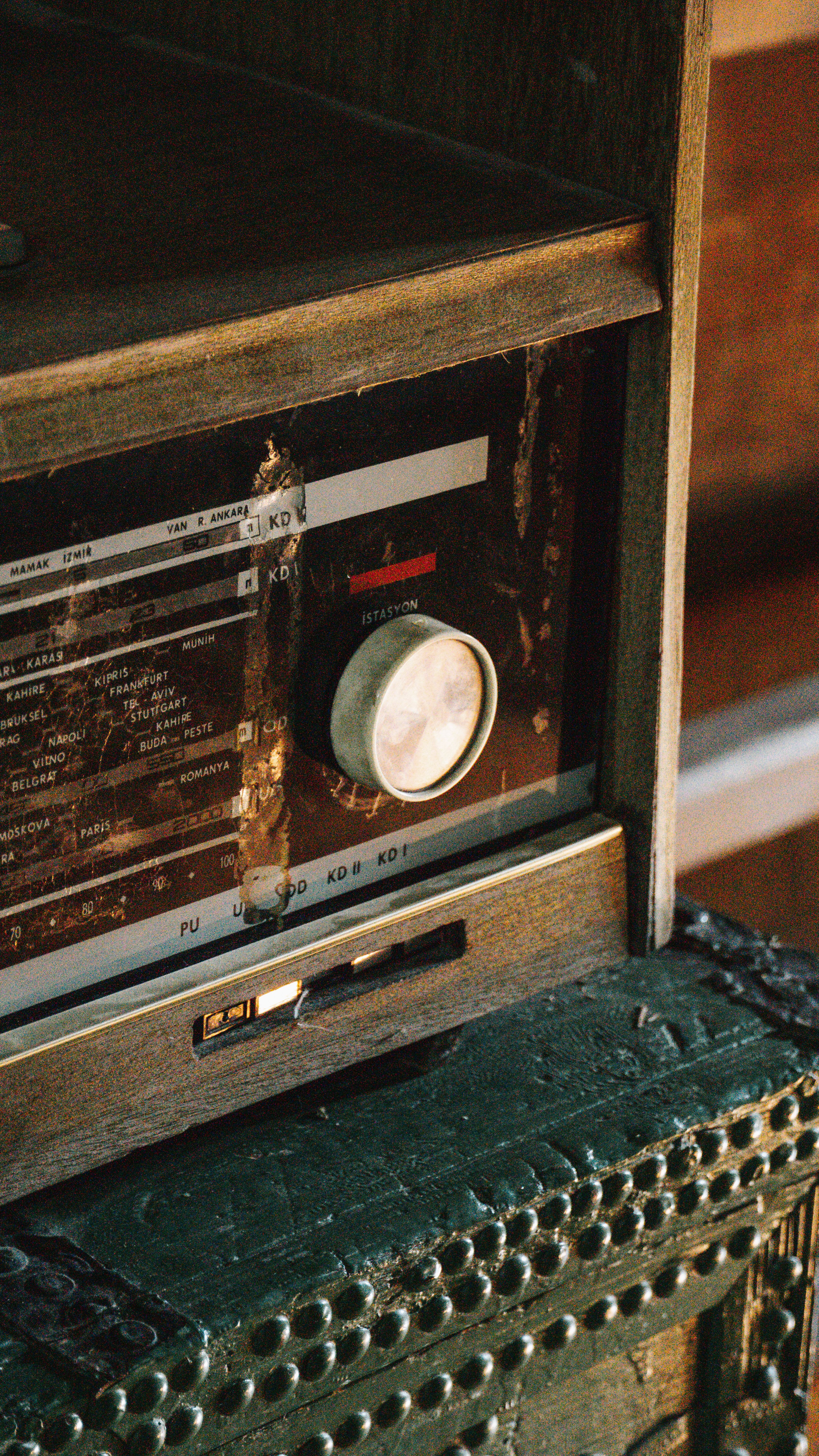 A close-up of a vintage radio on a rustic table, exuding a warm nostalgic feel.