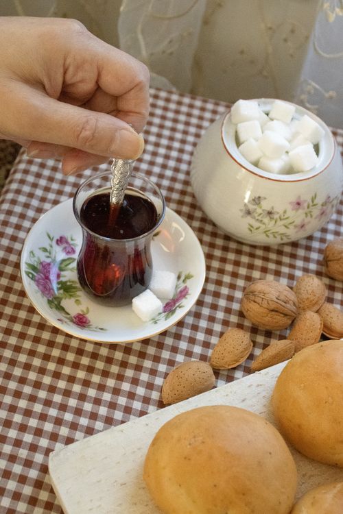 Free A cozy shot of tea, sugar cubes, and assorted nuts. Perfect for breakfast ideas. Stock Photo