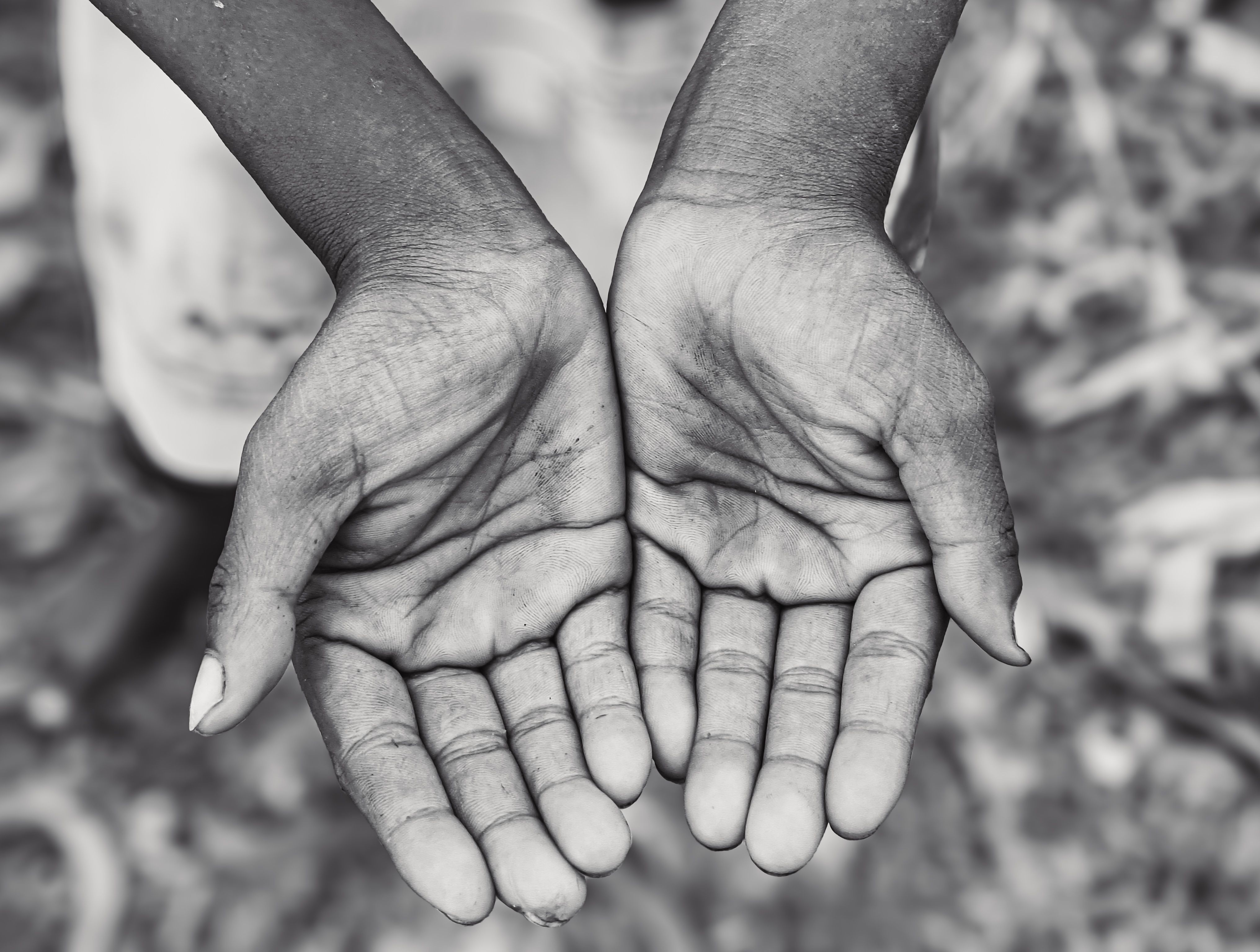 Close-Up of Open Hands in Black and White · Free Stock Photo
