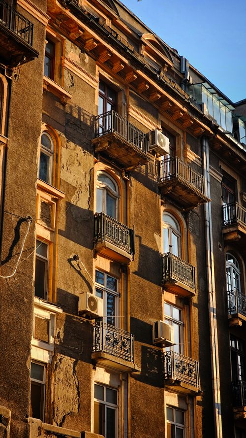 Free Stunning image of a historic building facade in Bucharest, Romania, captured in warm autumn light. Stock Photo