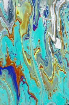 Colorful abstract fluid art with swirling patterns in vibrant hues of blue, orange, and teal.