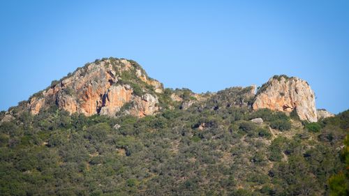 Free Breathtaking view of rocky hills in Cala Millor, Spain, under a clear blue sky. Stock Photo