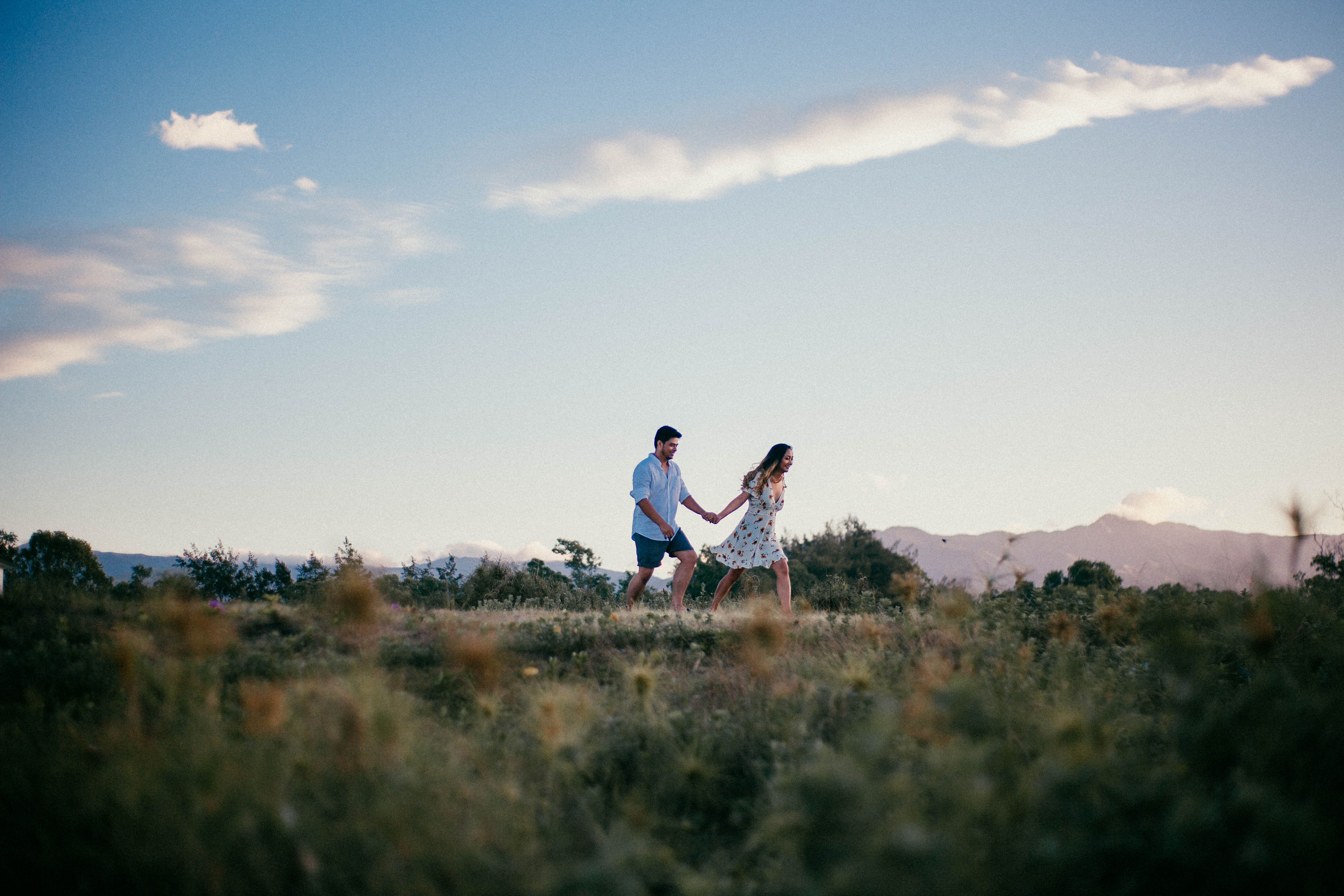 Man and Woman Standing on Grass Field · Free Stock Photo