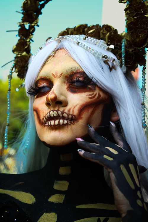 Free Close-up of a person with detailed sugar skull makeup and ornate costume, representative of Dia de los Muertos. Stock Photo