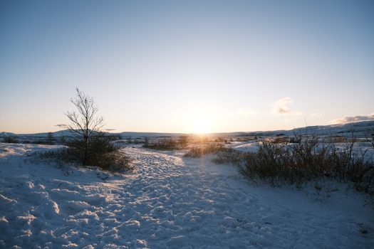 Breathtaking view of a snowy Icelandic landscape at sunset.