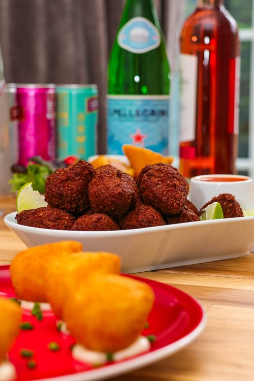 Free Delicious platter of kibbeh and croquettes served with drinks, perfect for a culinary experience. Stock Photo
