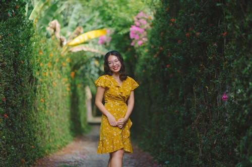 黄色の花のドレスを着て笑っている女性
