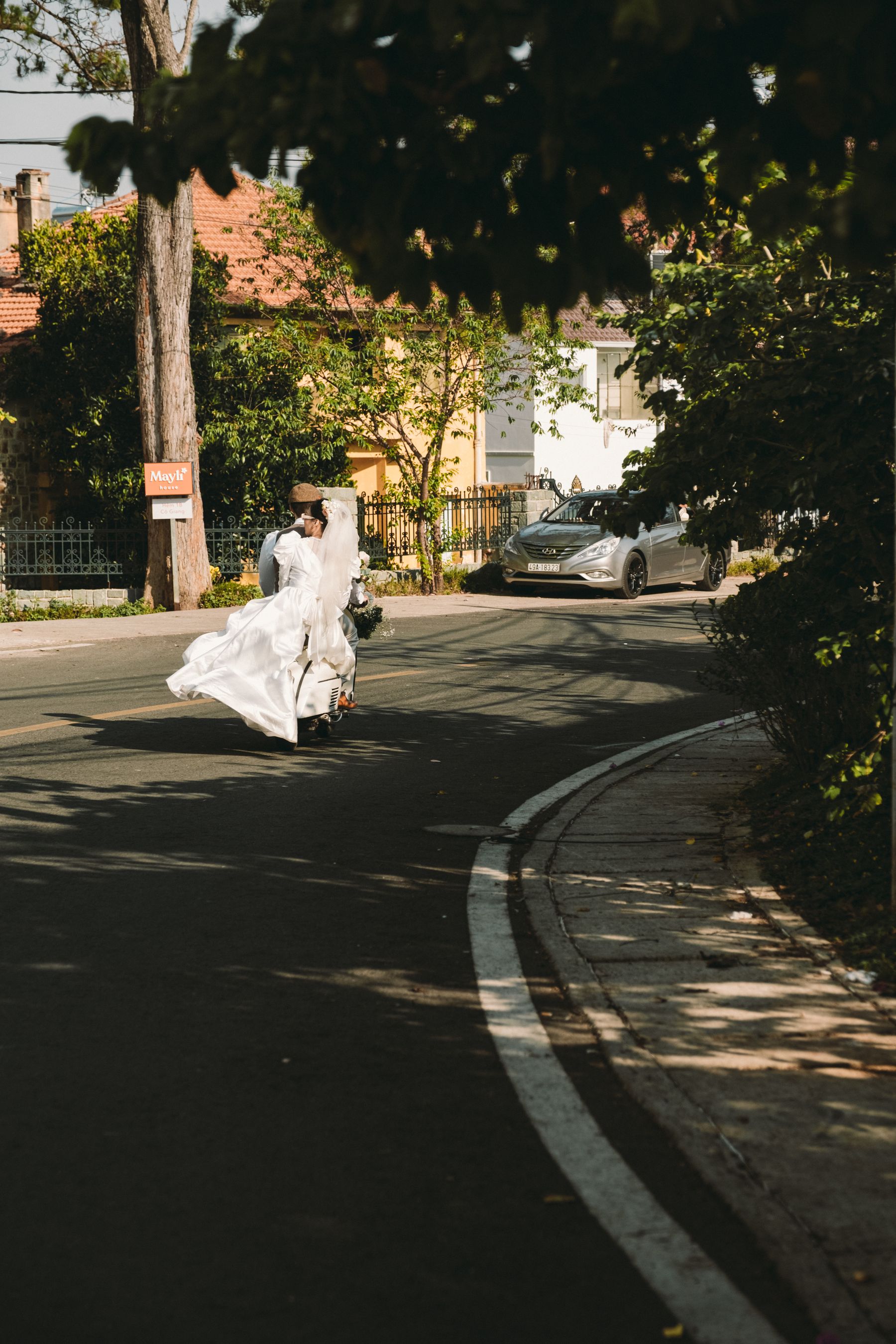 Bride and groom walking together in soft sunlight