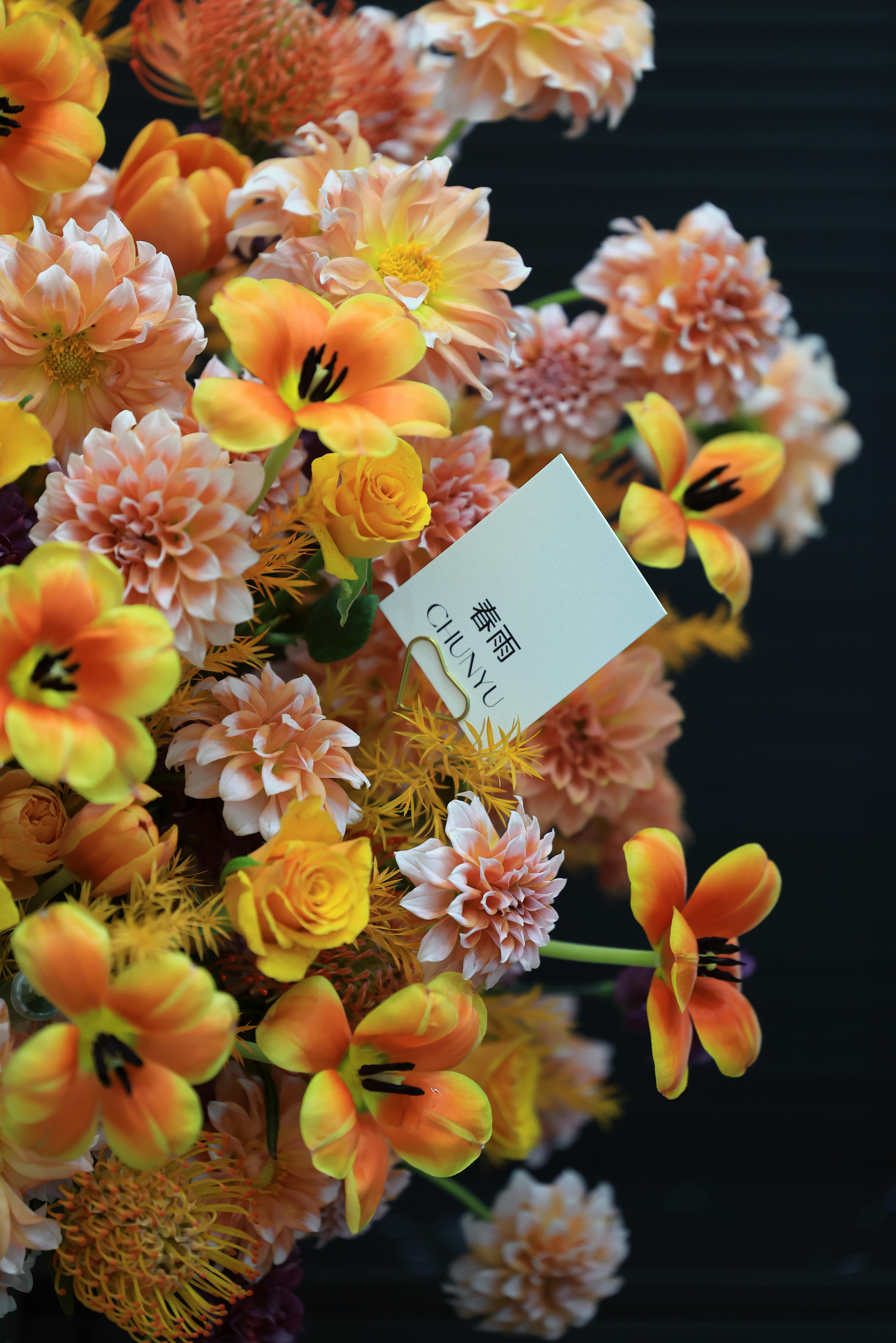 A close-up view of a colorful bouquet with orange and yellow flowers, perfect for floral arrangements.