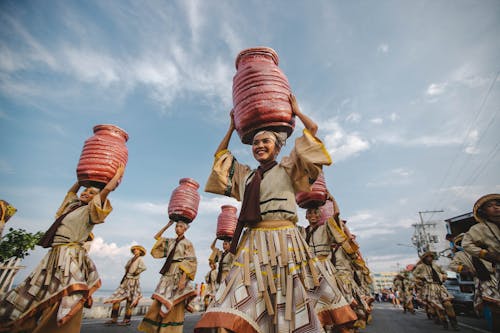 People Dancing on Street While Wearing Costumes