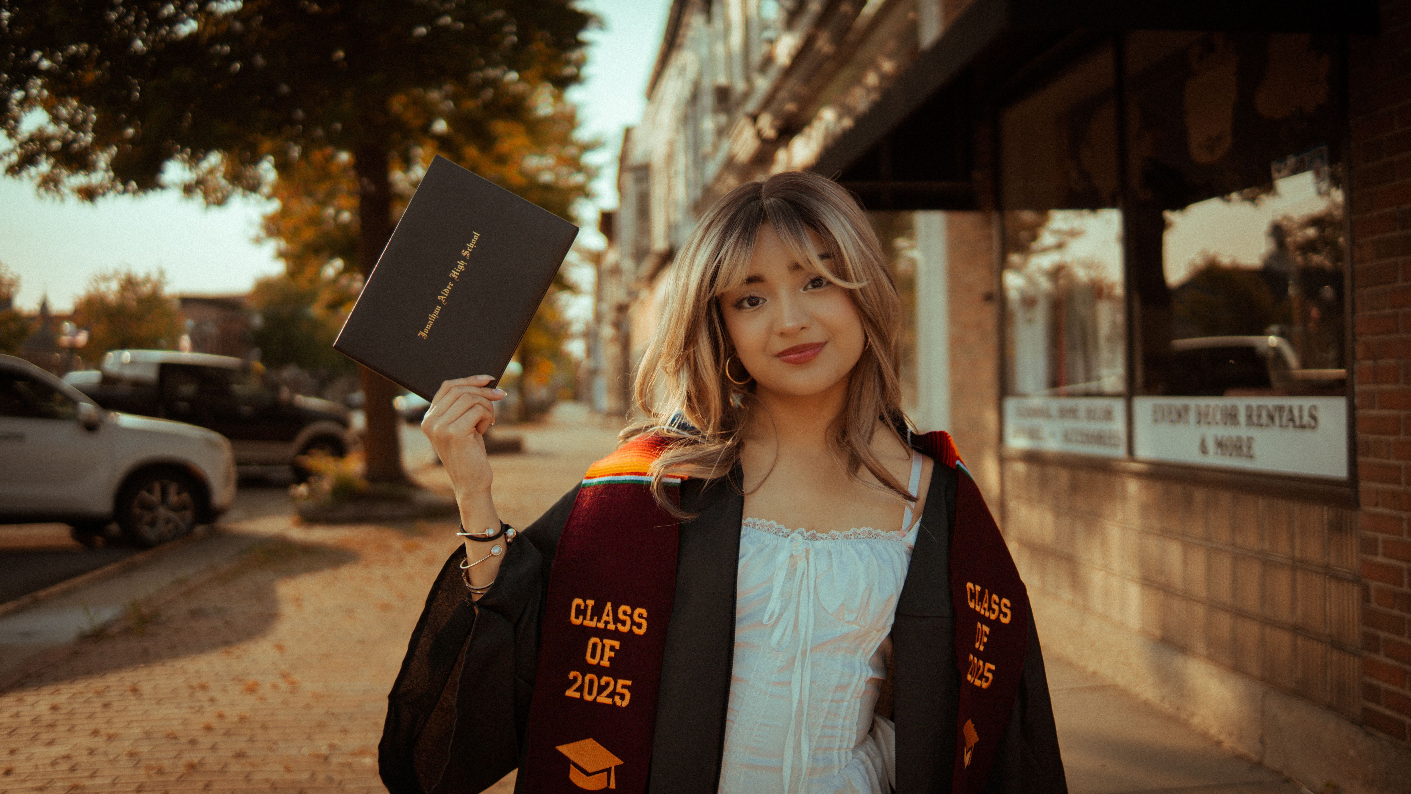Young Graduate Celebrates Outdoors in Cap and Gown · Free Stock Photo