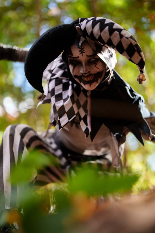 Creepy Jester in Black and White Costume Outdoors · Free Stock Photo