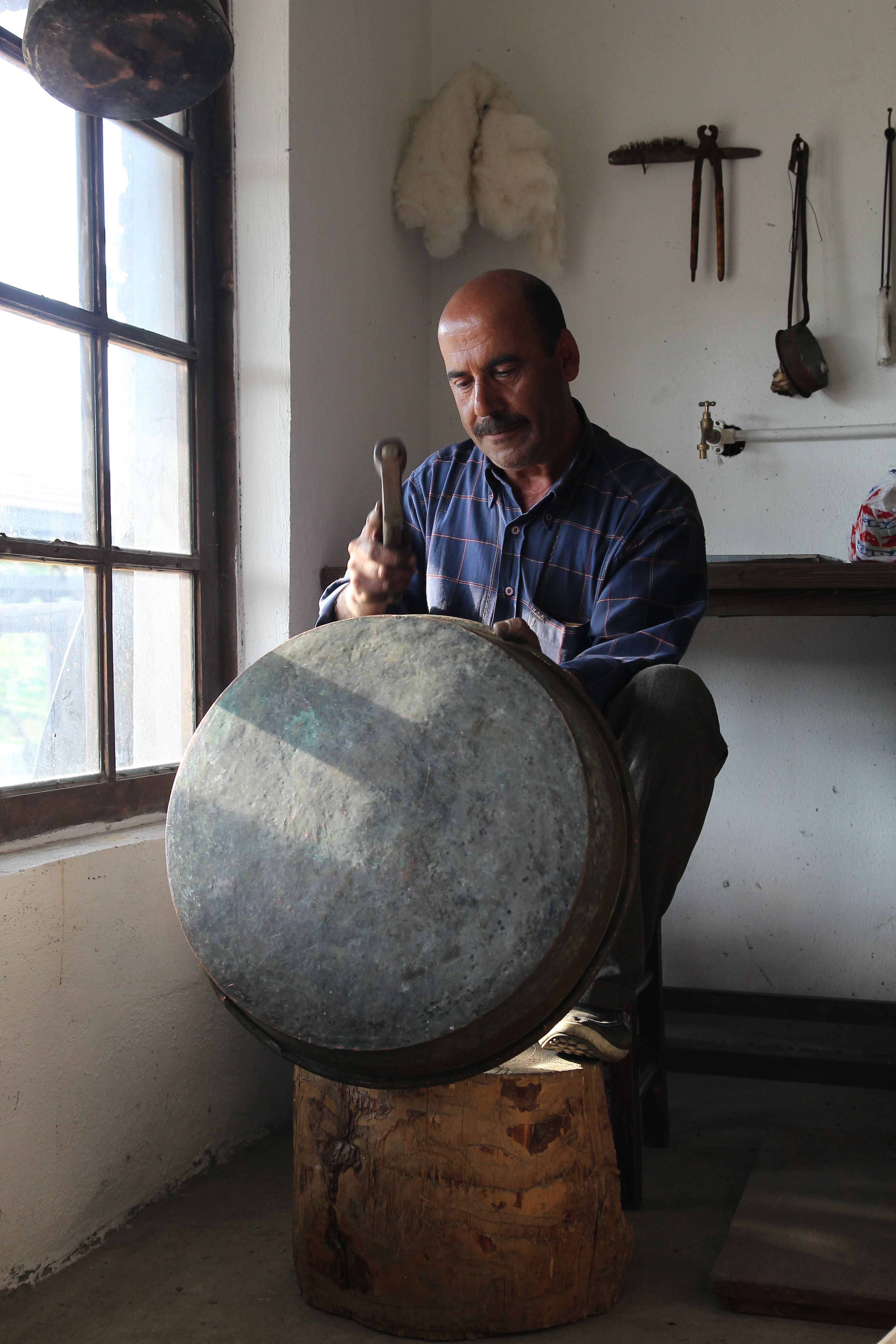 Man Crafting Metal Drum in Workshop · Free Stock Photo