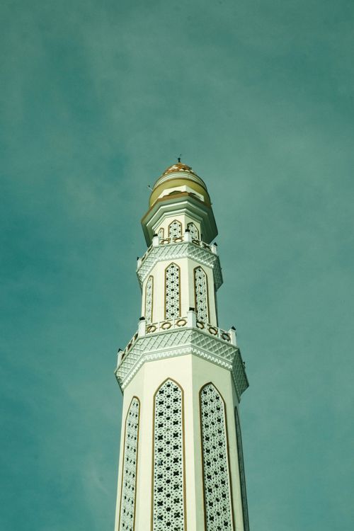 Free Stunning view of an Islamic mosque minaret in Indonesia, exemplifying intricate Islamic architecture. Stock Photo